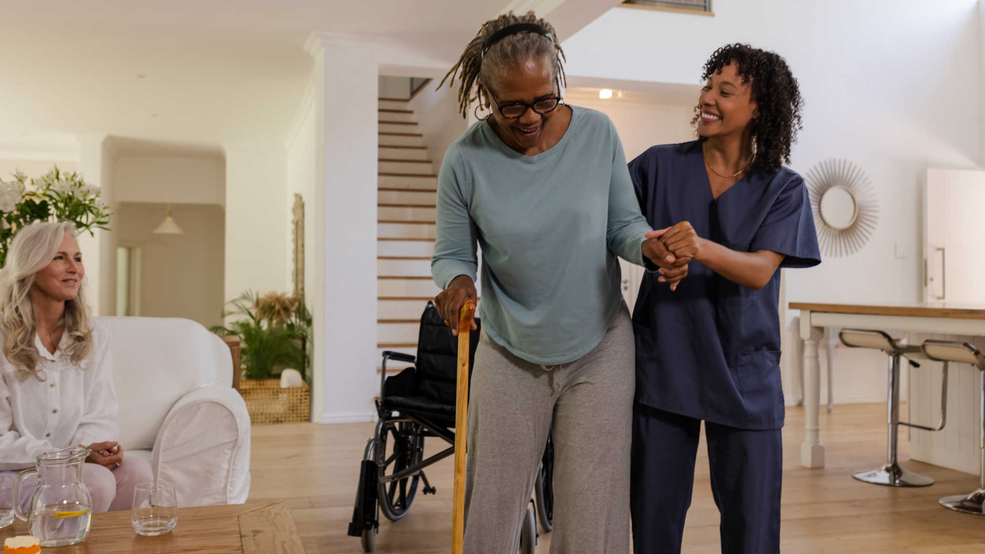 Person mobilising with a physiotherapist at home