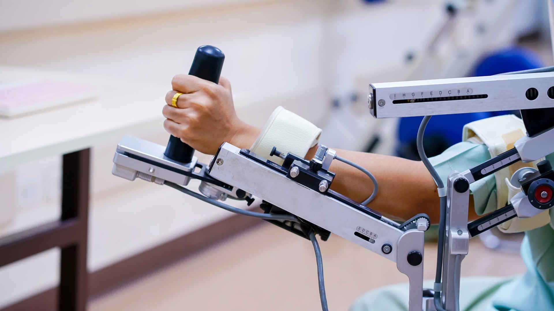 Patient with arm on a support during a rehab session